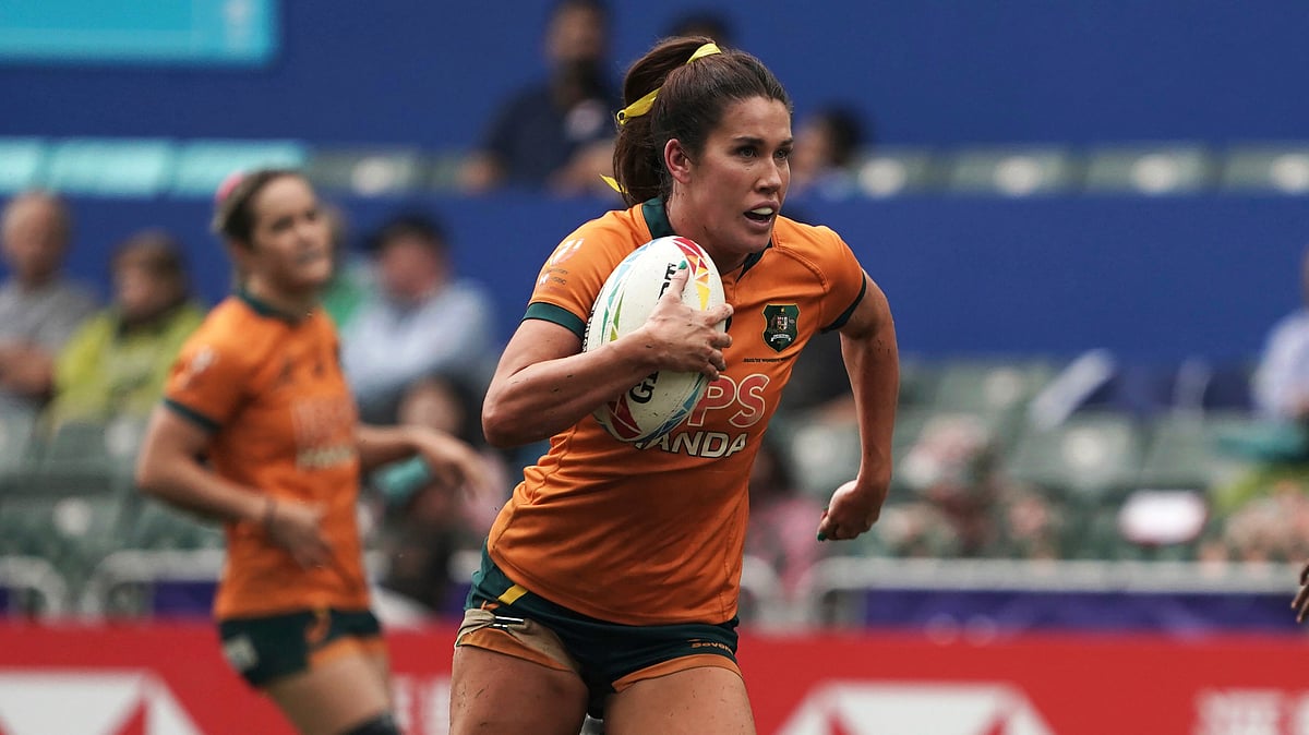 FILE - Australia's Charlotte Caslick runs to score a try against Fiji during the second day of the Hong Kong Sevens rugby tournament in Hong Kong, Saturday, April 1, 2023. Caslick will lead Australia's world series champion squad to the Paris Olympics, where she's aiming to win her second gold medal after taking the honors when rugby sevens made its debut at the Summer Games in 2016.

 -  (AP Photo/Anthony Kwan, File)

